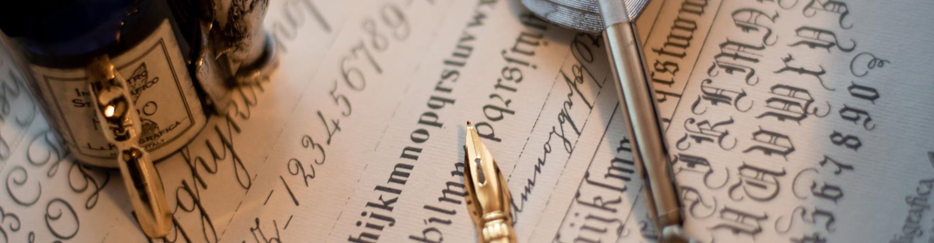 macro-shot-quill-set-ink-bottle-piece-paper-with-calligraphy-it