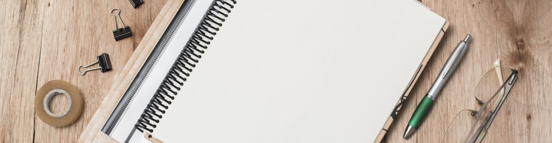 top-view-blank-spiral-book-eye-glasses-plant-office-supplies-table